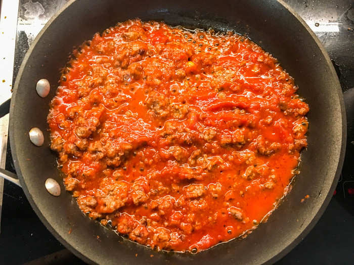 First, I wanted to test how the grounds cooked on their own. My recipe: simple meat sauce. I was so excited about how well the Impossible grounds were browning that I forgot to take pictures of the process. The "meat" browned on the bottom as soon as it hit the pan, and continued to brown at the rate that beef does. It shrank, stiffened, and rendered fat — again, just like ground beef does.