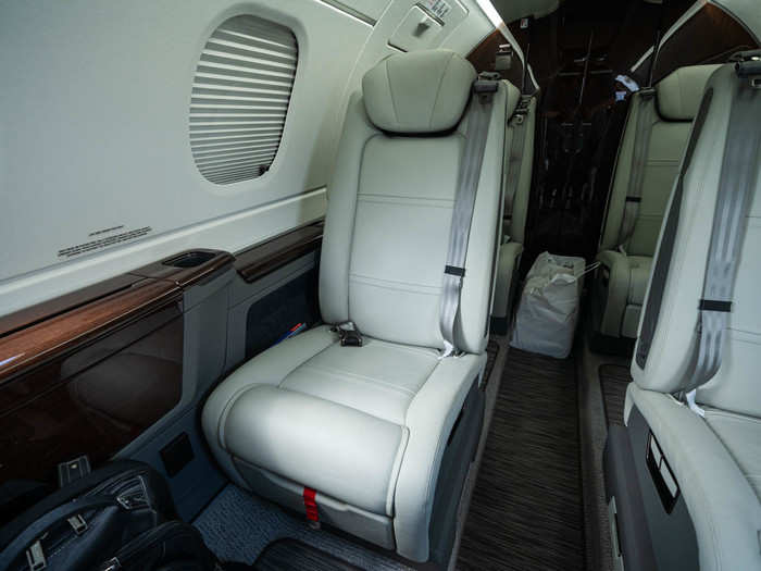 The cabin is sleek and comfortable, with six bucket seats (the other two passengers can sit on the couch, for a total of 8).