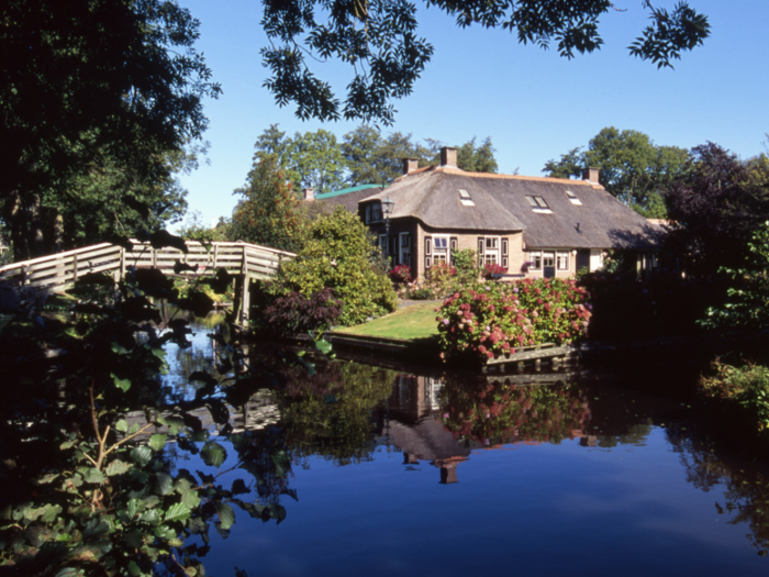 There are more than 55 miles of canals and over 180 wooden foot arch bridges to aid in travel, according to Condé Nast Traveler.