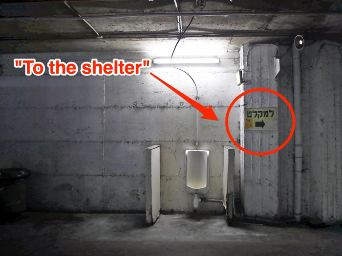 The sign to the right of the urinal below directs patrons to the bomb shelter.