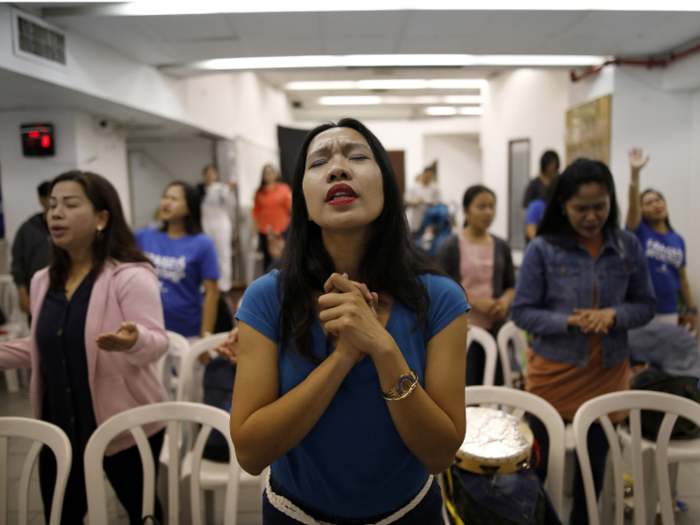 The station fosters several communities outside of the arts. There is a Filipino church in the building where worshipers like Merry Christ Palacios, seen here, come to pray. Palacios says she also gets her shopping done inside the building.