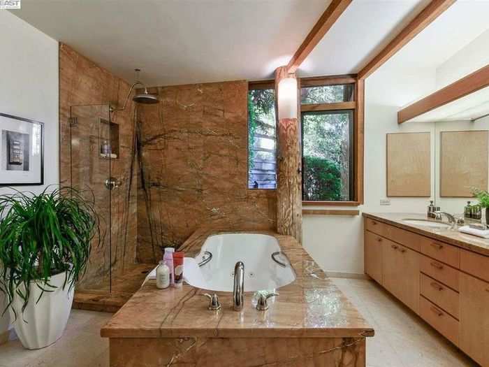 In a bit of an unusual setup, the tub is in the center of the bathroom as a focal point of the room.