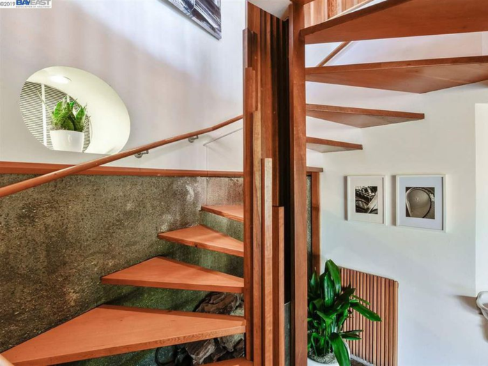 A spiral staircase has the same light, natural feel as the rest of the home.