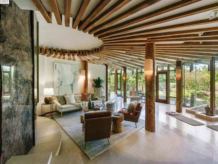 Wood beams offer support without closing off living areas the way that walls would.