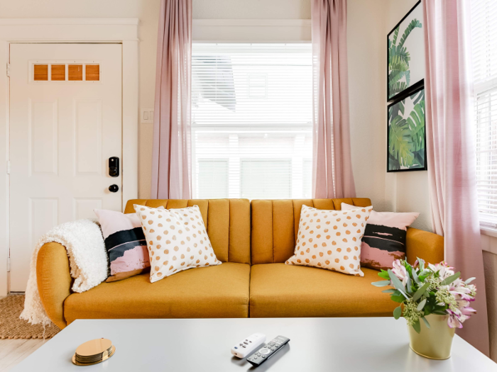 The home is beautifully decorated, from the stylish mustard couch to the bright and inviting emerald green dining room chairs. An outdoor seating area tops it all off, making this small but inviting space the perfect choice for a getaway.