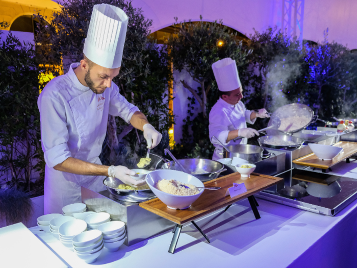 A huge buffet table stretched across one side of the room. Chefs were making risotto and ravioli dishes in real time, serving them upon request in small individual bowls.