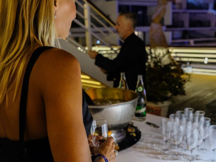 Guests could grab a glass of Champagne from the bar or from servers who weaved through the crowd carrying trays of bubbly.