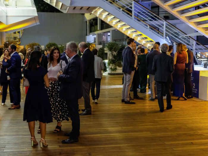 The event started at 8:00 p.m., and when I arrived at about 8:20, people were milling about outside on the deck of the yacht club, chatting with glasses of Champagne in hand.