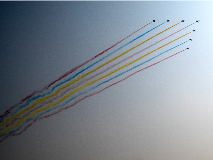 Military aircraft streaked rainbow smoke through the sky over Tiananmen Square.