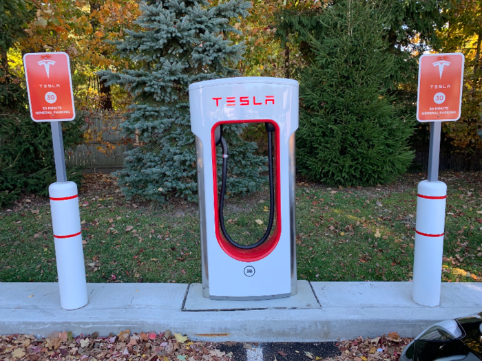 The station I chose was tucked into the corner of a strip mall parking lot, but the distinctive appearance of Tesla