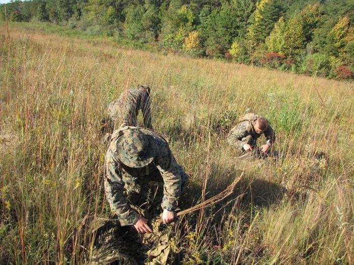 The snipers were given 10 minutes to customize their ghillie suits, in this case a mesh cover to which students attach vegetation to help them blend into their environment. A top sniper can complete this process much faster.