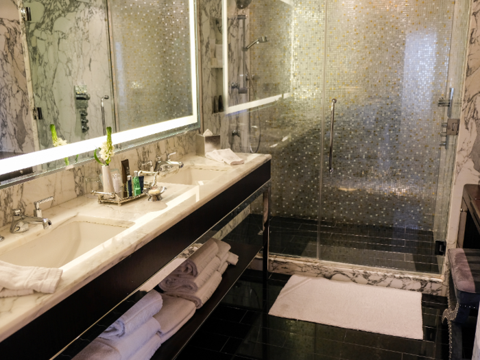 The bathroom features plenty of sleek white marble.