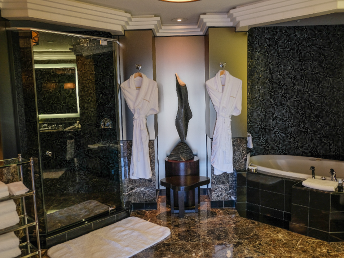 In the master bathroom is a jetted bathtub, microfiber robes and slippers, a bidet, and Molton Brown bath products.