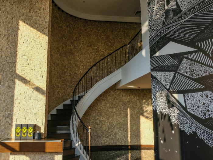 Past a 29-foot-wide mural by French artists Alex et Marine is a grand curving staircase that leads up to the next floor, although the suite also has its own private elevator.