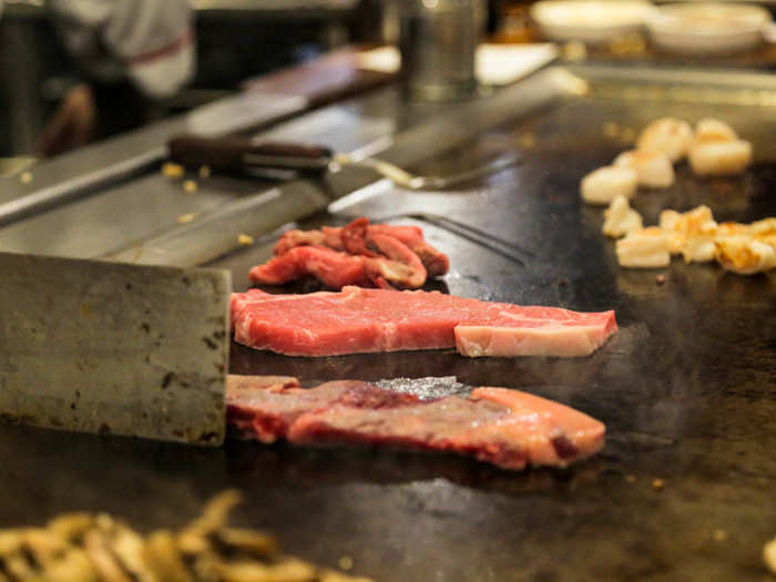 As the seafood was still cooking, Chef Haque slid a few cuts of beef onto the grill top.