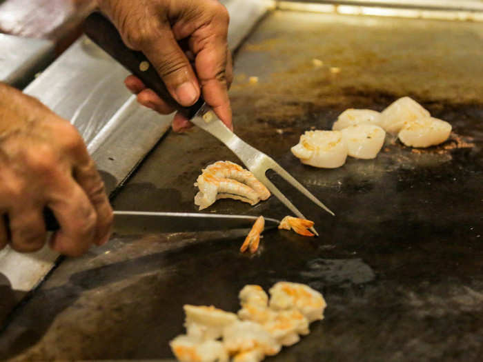 Chef Haque skillfully removed the tails from the shrimp.