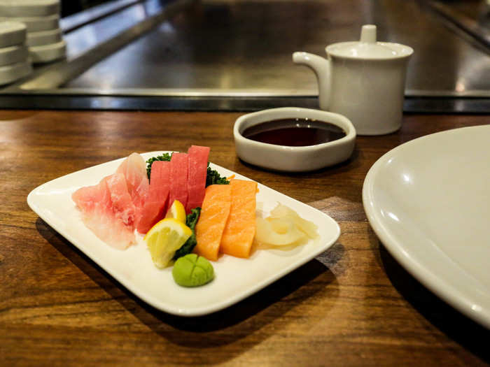 My sashimi sampler arrived with the chef. On the plate were snapper, tuna, and salmon sashimi.