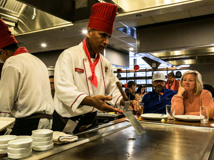 Haque, our chef, arrived with his cart and greeted us with a bow and an attempt at "Irasshaimase" — the Japanese phrase used to welcome guests to a store or restaurant. He immediately began flipping spatulas.