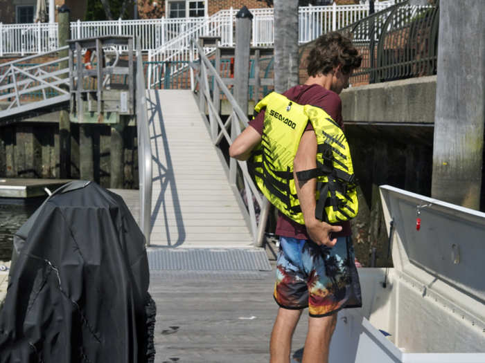 ... and put his life vest in a chest on the dock.