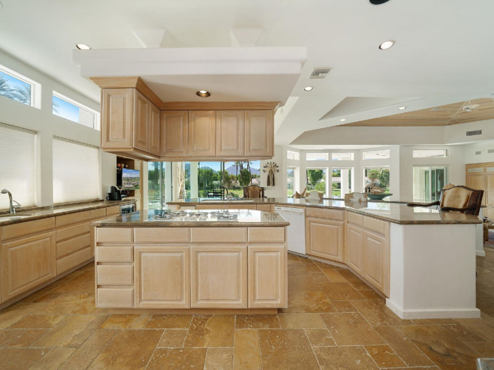 The kitchen has a breakfast bar, a center island, and granite counter tops throughout.