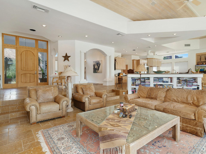 The open floor plan connects the foyer, the living room, the dining room, and the kitchen.