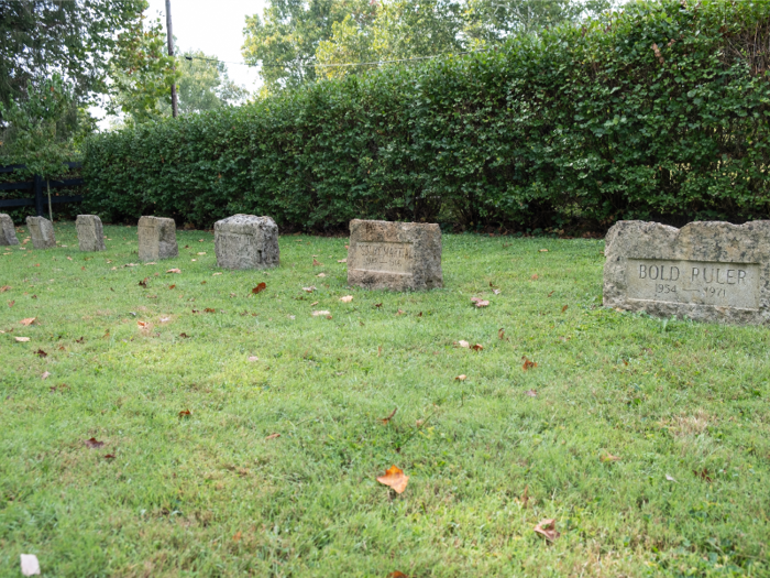 In a small, simple cemetery behind the farm office, 22 of Claiborne