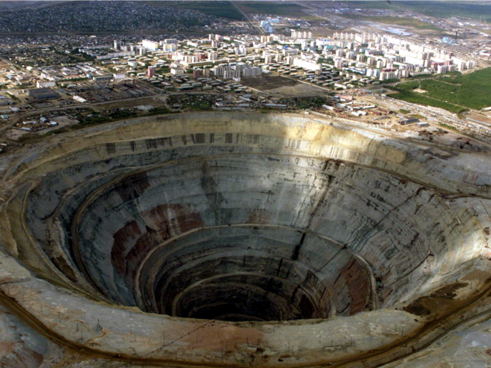 In eastern Siberia, the Mirny diamond mine, the second largest hole in the world, was constructed under orders from former Russian leader Joseph Stalin, to produce diamonds for the Soviet Union. It goes 1,722 feet into the ground, and has a diameter of 4,100 feet.