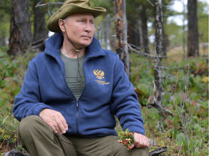 Flowers in hand, Putin took a moment to look out wistfully over the mountainous region.