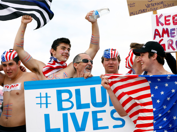 At the same rally, men held a half covered sign that says, "Blue Lives Matter," in support of the police. They also stuck Trump stickers to their bare chests.