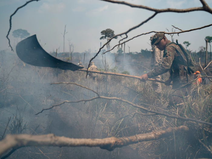 Some of the firefighters wield eight-foot poles with mats attached to the end, and slap them down on the fires. Or they shoot water from hoses attached to water tanks, like a "child