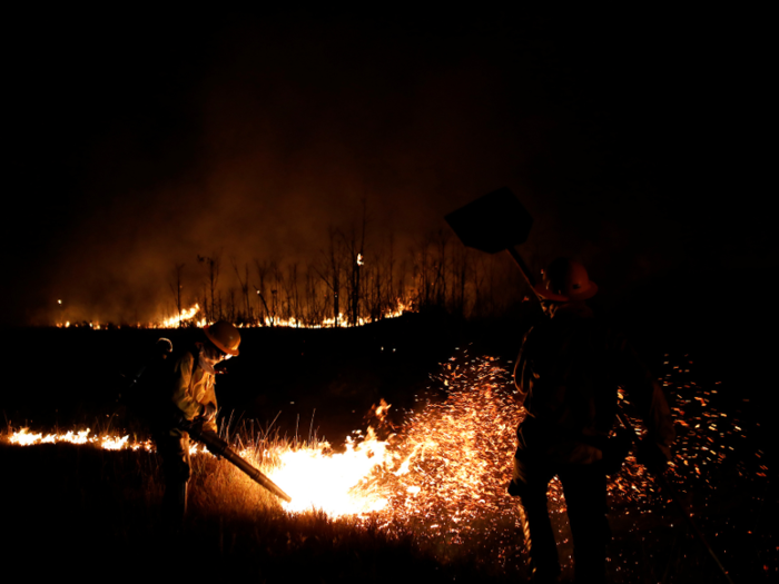 Here, a firefighter from the Brazilian Institute of the Environment and Renewable Natural Resources (IBAMA) attempts to control the direction of the fire on indigenous land in September.