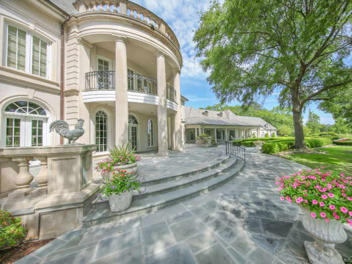 The home has two stories, with garden detailing around the entry way. And it can all be yours for a cool $8.95 million — or potentially less, if you want to take your chances bidding in the auction.