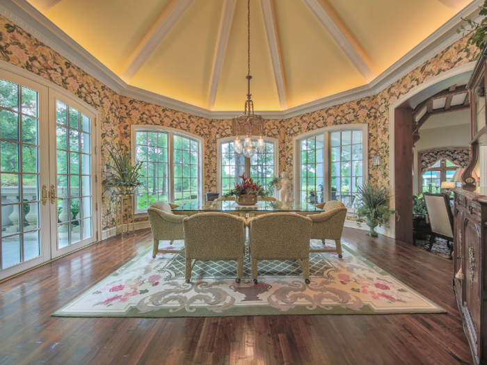 The French-style windows look out on a manicured garden.