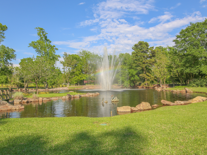 The surrounding property includes three ponds and a creek, with a fresh water well.