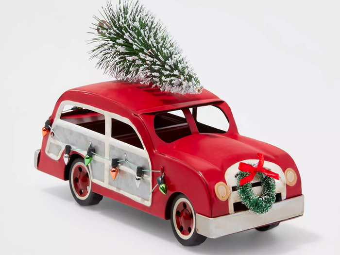 A mini car hauling a frosty tree