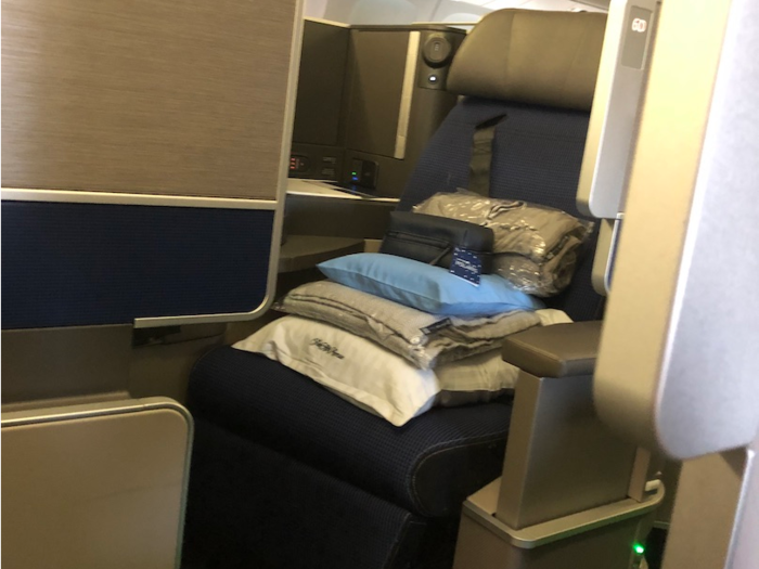 The Polaris section on the plane was quite large. There were 16 rows totaling 46 seats on this Boeing 767-300. A pile of goodies welcomed me on the plane: pillows, blankets and complimentary toiletries.