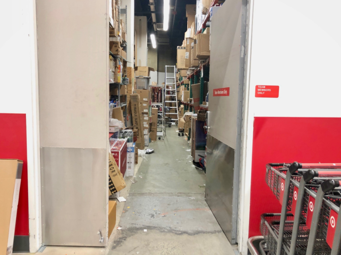 The back room in this Target looked disorganized and seemed to have items spilling from the shelves.