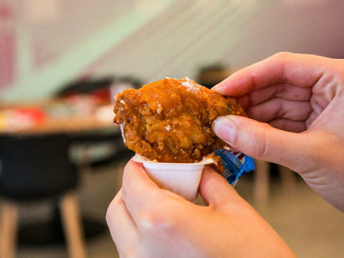 Her wing was too wide for the ranch cup! Frustrated, this taste tester ultimately wrangled her wing into the cup lengthwise.