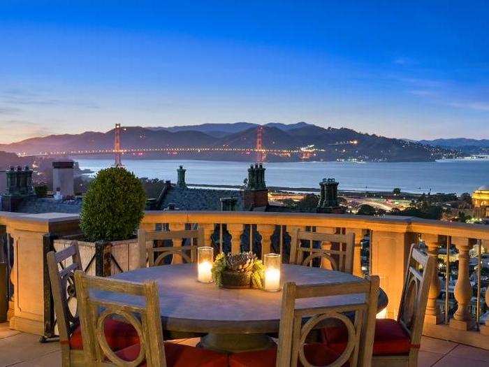 At night, the Golden Gate Bridge is illuminated across the bay.