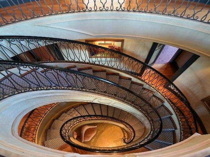 A dramatic spiral staircase winds through the center of the home.