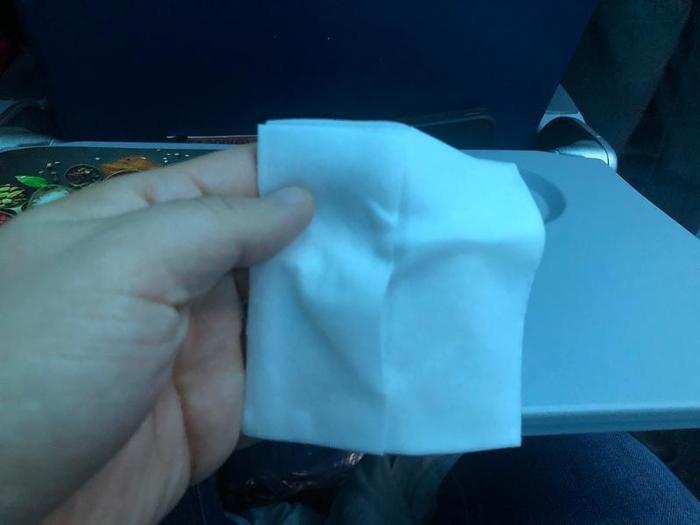 A few minutes after takeoff, flight attendants came around with hot towels. This is usually something you