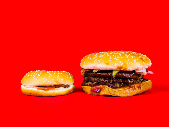 The burgers look like the before-and-after photo of a weightlifter in training. The BBQ Bacon Triple Whopper weighs in at 1270 calories, while the hamburger packs a measly 240 calories.