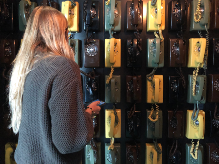 To open the speakeasy, you have to use your cell phone to call one of the rotary phones that cover the walls. You don