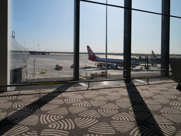 The departures hall boasts giant windows, through which sunlight seeps and you can watch planes arriving and departing.