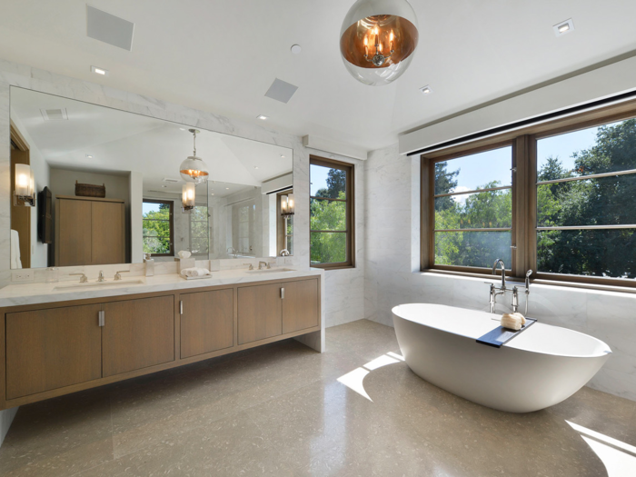 The upstairs bathroom has its own soaking tub with garden views.