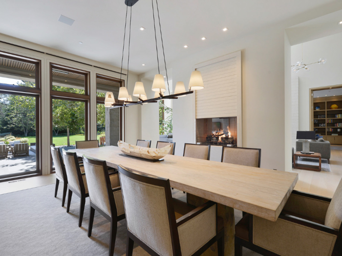 The dining room, which includes an elevated limestone fireplace at eye-level, can seat at least 10 people.