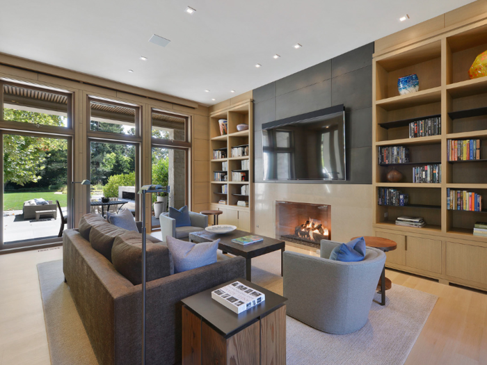 The living room features a limestone fireplace and built-in shelving.