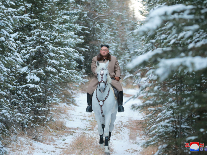 Kim rides an immaculate, snow-white horse to match his surroundings. But it