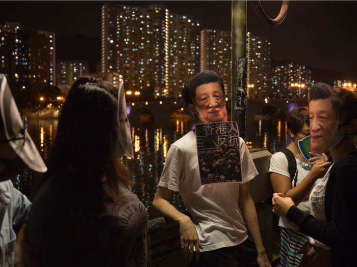 Others donned masks depicting Chinese President Xi Jinping in effort to mock the communist leader.