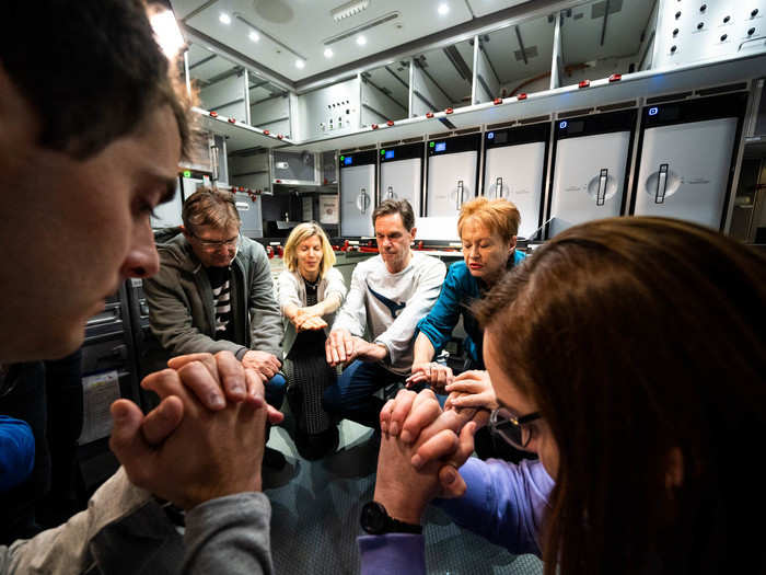 A little while after the first meal, Dr. Marie Carroll, the researcher leading the passenger jet-lag study, brought all of the participating passengers to the empty rear galley for a short group exercise, including stretches and squats.